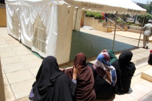 Stock photo of Muslim women next to a tent outside a Nairobi court. In the spring of 2019, the High Court of Kenya ruled that many of the nation’s laws violate the constitutional rights of children of unmarried parents. Alumni of Georgetown Law's International Women's Human Rights Clinic filed the complaint in the case back in 2013.