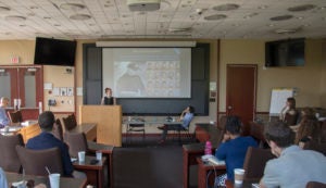 Clare Garvie (L'15) and Visiting Professor Alvaro Bedoya in front of a classroom.