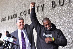 Justin Brooks (LL.M.'92) and Brian Banks celebrated in 2012 after Banks's wrongful conviction was reversed by a California court. This scene outside the courthouse is depicted in the "Brian Banks" movie, in theaters on August 9, with Greg Kinnear playing Brooks and Aldis Hodge playing Banks. (Photo Courtesy California Innocence Project.)