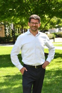 Mitchell Bailin standing outside and smiling at the camera