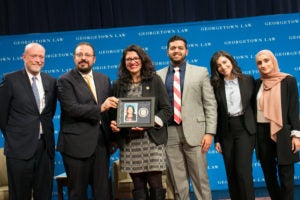 Georgetown Law Dean William M. Treanor, Muslim Chaplain Imam Yahya Hendi, Rep. Rashida Tlaib (D-Mich.), Hassan Ahmad (L'21), Sarah Jonny (L'21), and Tooba Hussain (L'21) onstage in Hart Auditorium.