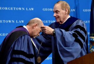 Dean William M. Treanor receives medal from Associate Dean James V. Feinerman.