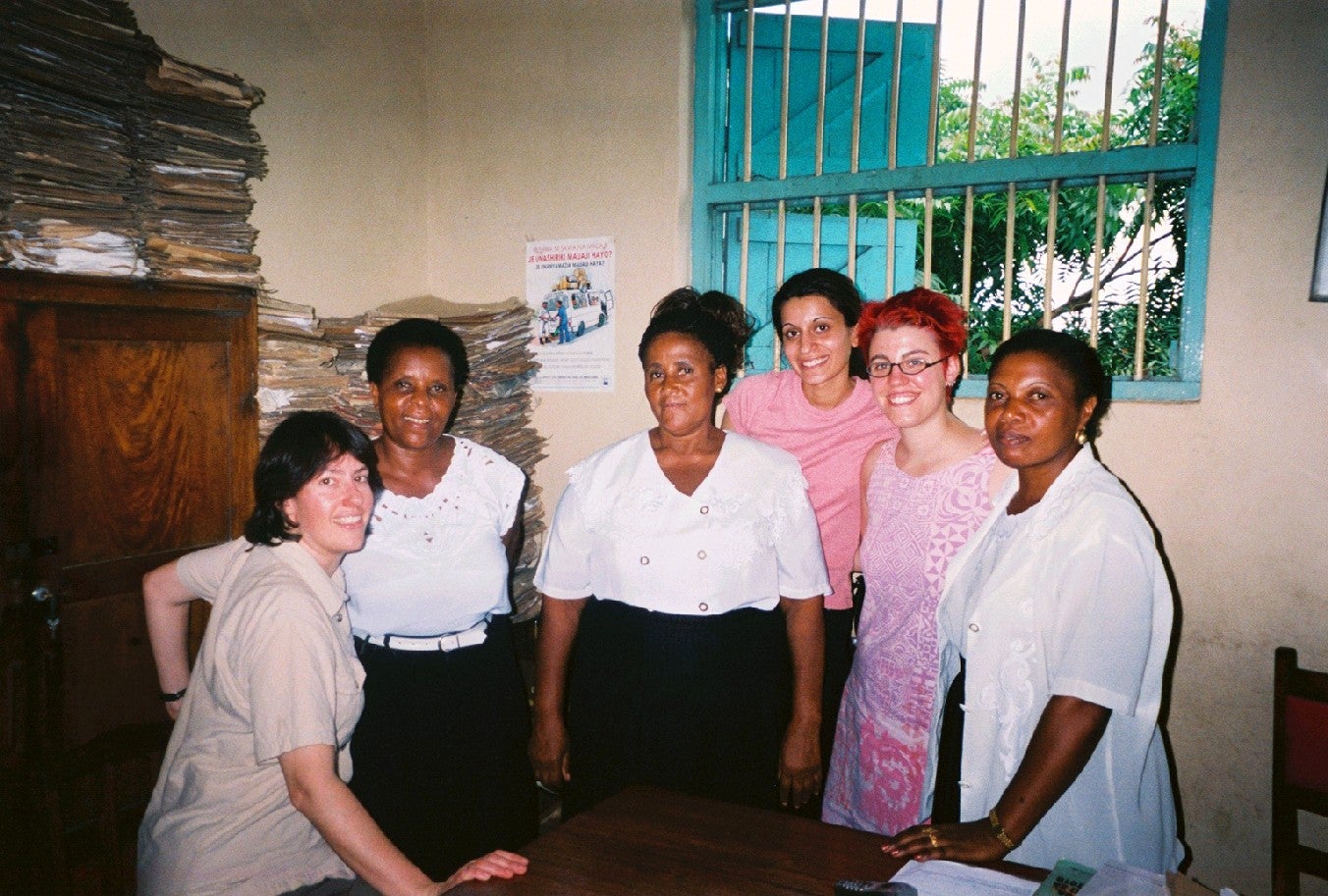 Two Student Advocates, Kalsoom Malik and Vanessa Brocato, standing with three other women in the Women’s Legal Aid Centre office in Dar es Salaam.