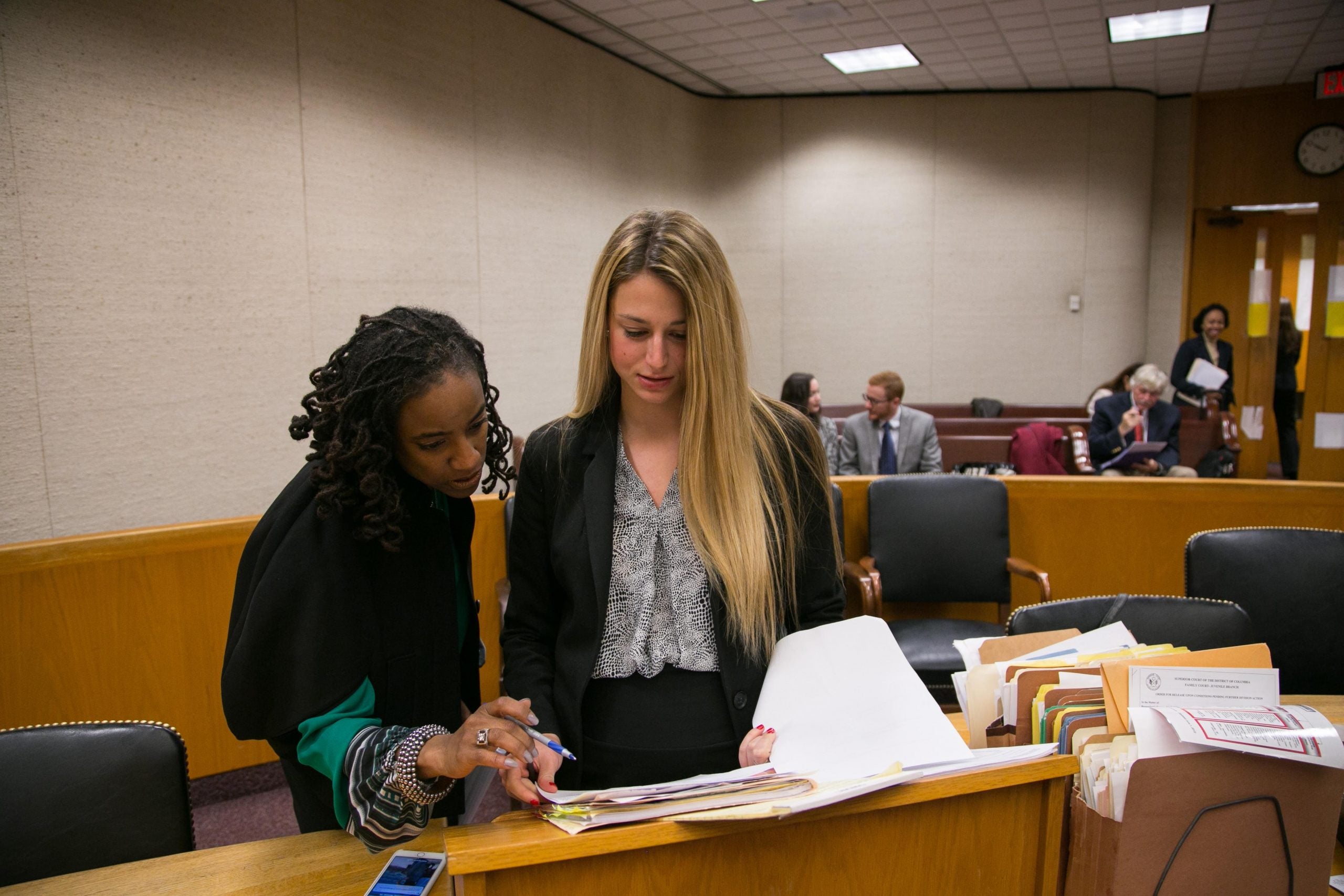 Professor Kristin Henning assists a Student Attorney in court