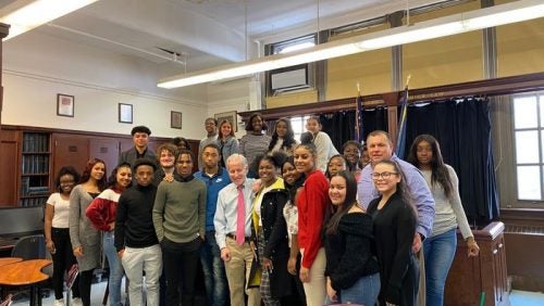 Dean Cornblatt posing with Curtis High School students