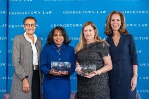 Georgetown Law Associate Dean for Centers and Institutes Elizabeth Hayes Patterson (left) and Georgetown University Alumni Association Director Julia Farr (right, C'88, P'19, P'21) at the Georgetown Law Women's Forum, giving the 2020 Georgetown Law Alumnae Award to Leslie Thornton (L'83, L'16, second from left) and U.S. District Judge Virginia M. Hernandez Covington (second from right, L'80). The Alumnae Award was established in 1998 to recognize women graduates of the Law Center who exhibit excellence in their profession and dedication to Georgetown Law.