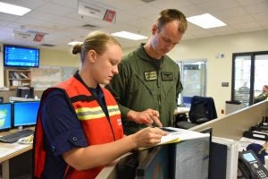 Melissa McCafferty (left) was the first female officer assigned to a fast response cutter, a type of patrol boat, as part of her service with the Coast Guard.