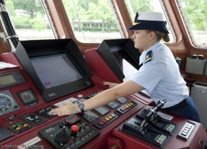 Melissa McCafferty on a boat patrol checking the controls.