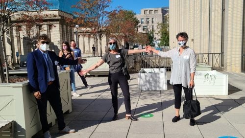 Georgetown Law Professors Anupam Chander, Erin Carroll and Rima Sirota outside of Bernard P. McDonough Hall.