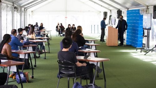 International students holding F-1 visas took part in an in-person class held under a tent on the green outside of the Edward Bennett Williams Law Library.