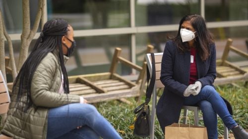 Associate Dean Madhavi Sunder speaks to a student outside of the Scott K. Ginsburg Sport & Fitness Center.