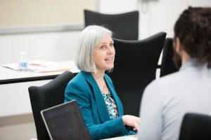 Vicki Girard speaking with students