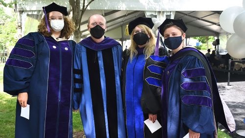 Dean Treanor poses for a group shot with masks.