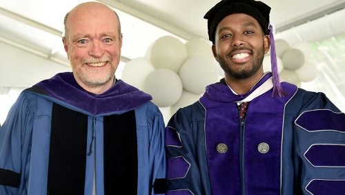 Dean Treanor poses with a student during BLSA ceremony.