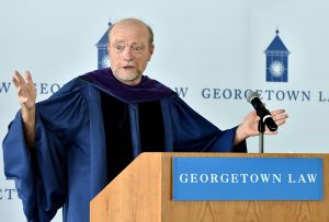 Dean Treanor speaks to graduating students outside on the Tower green.