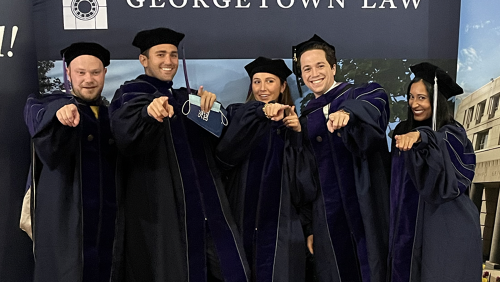 Graduating students pose for a group photo.