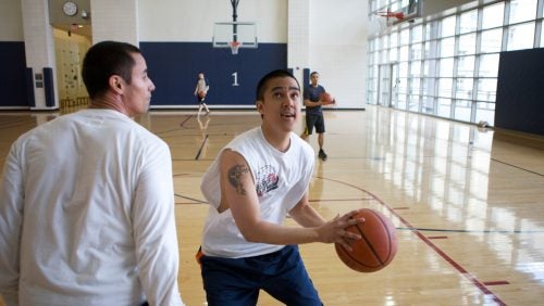 students playing basketball together