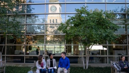 students sitting outside the fitness center