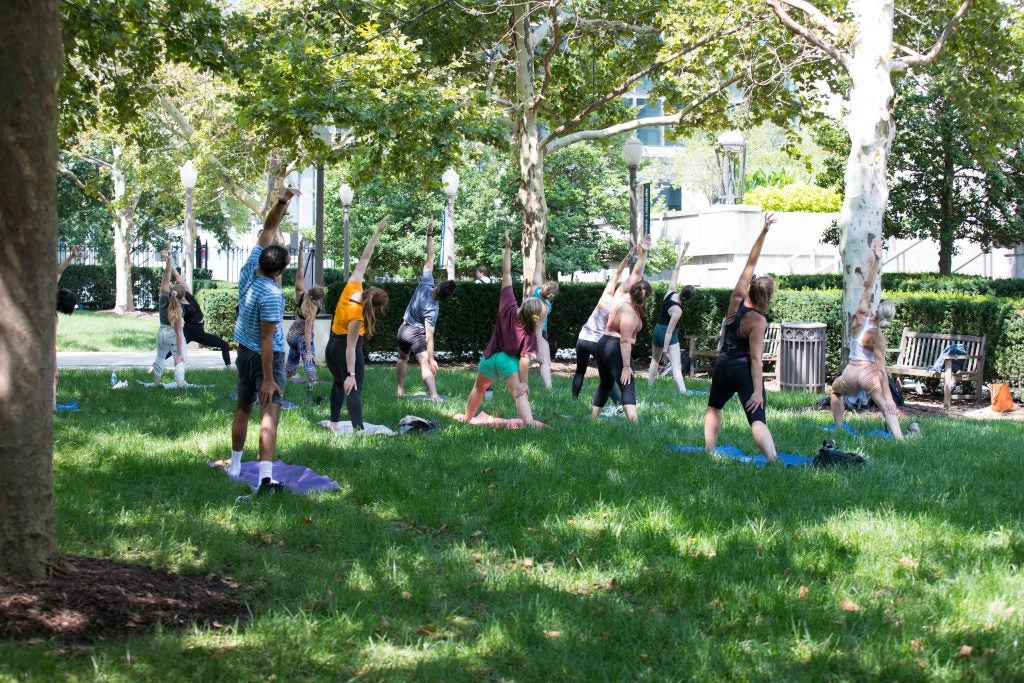 Students gather outside for outdoor yoga.