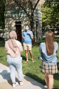 A student ambassador gives a tour around campus.