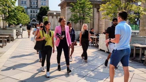 tour guide speaking to prospective students walking