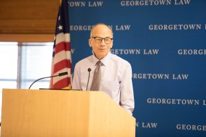 Professor Gostin speaks at podium with Georgetown Law backdrop.