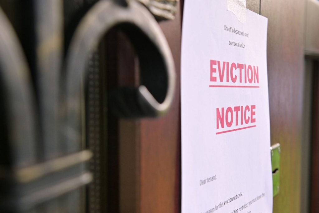 A door with a form reading "Eviction Notice" posted on it