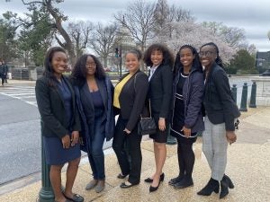 Six students stand outside the U.S. Capitol Building