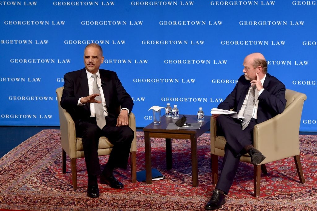 Former Attorney General Eric Holder and Dean William M. Treanor on stage at Georgetown Law's Hart Auditorium