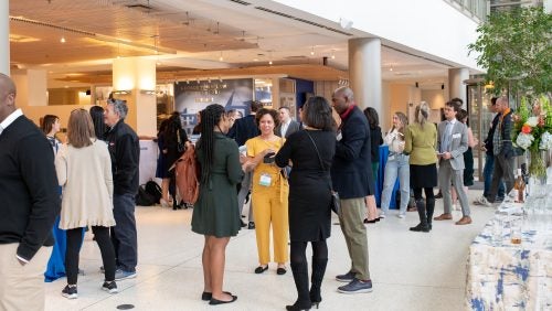 Alumni and students in conversation at a reunion reception