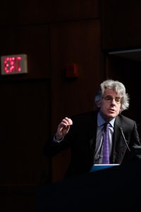 Professor M. Gregg Bloche on stage in Hart Auditorium