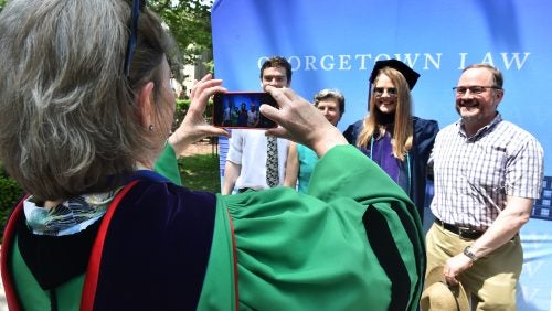 A group of people posing for a photo on the Law Center campus