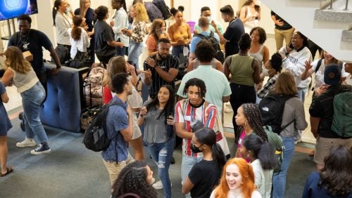 A large group of students participating in an icebreaker exercise