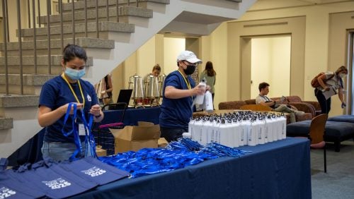 A table holding Georgetown Law tote bags and other accessories