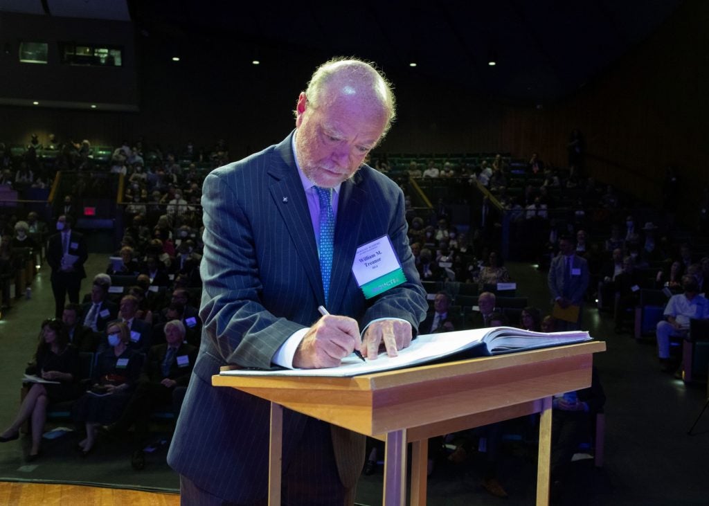 Dean William M. Treanor signing the American Academy of Arts and Sciences' Book of Members