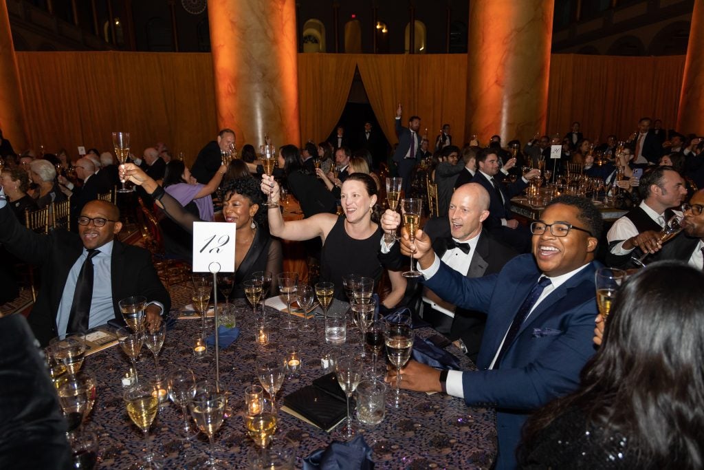 Alumni raising their glasses for a toast