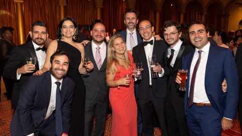 A group of alumni together at the reunion gala