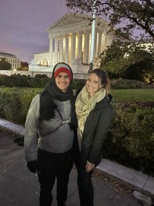 Two students smiling outside the Supreme Court