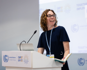 Kate Zyla stands at a podium at the COP27 conference.