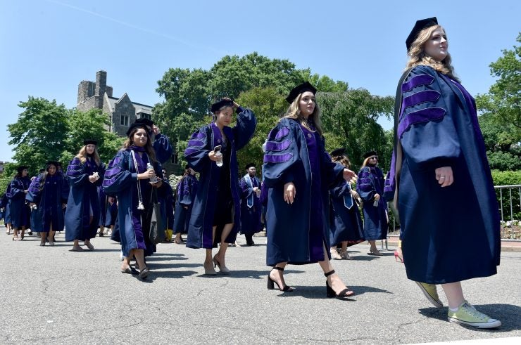 Georgetown Law graduates process outside on Healy Lawn.