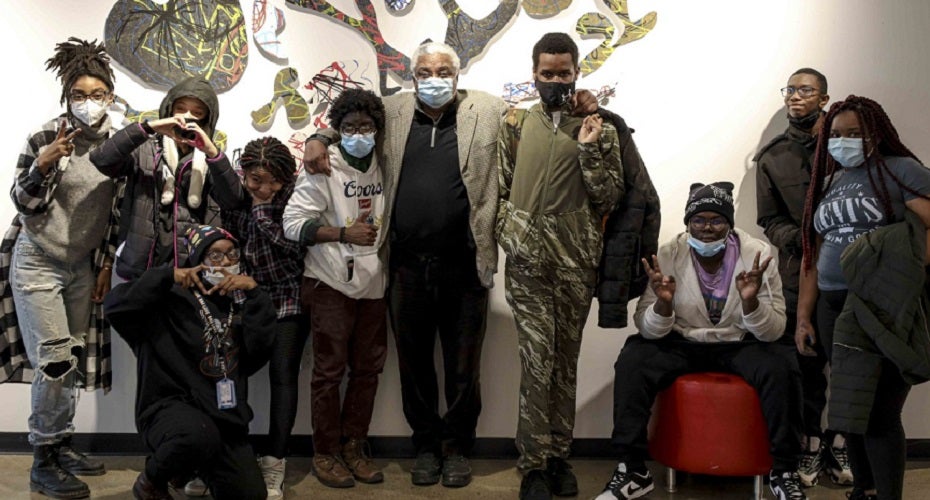 A photo of artist LeRoi Johnson standing with a group of youth participants in a Buffalo arts organization.