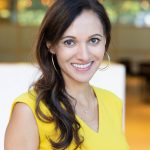 Anjali Patel, a woman with long dark hair wearing yellow