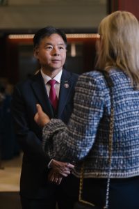 A man speaking to a woman with her back to the camera