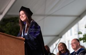 Mariaeugenia Gurdian, a woman with long dark hair wearing graduation regalia, speaking at the 2023 Georgetown Law Commencement