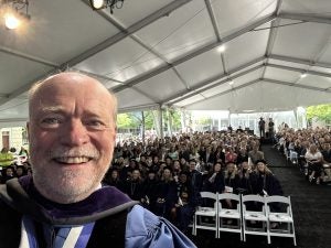 A selfie taken by Georgetown Law Dean William M. Treanor of himself with an audience of graduating students