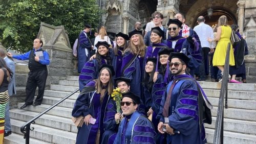 A group of students posing for photos together on the Georgetown campus