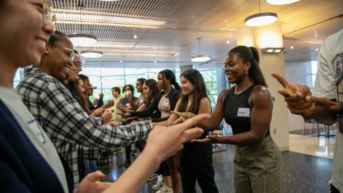 Two rows of students facing off in a game