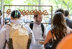 Students standing around a display of pretzels