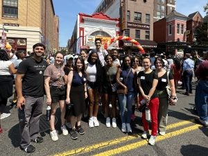 A group of students standing outside the restaurant Ben's Chili Bowl