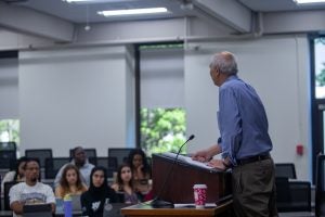 A Georgetown Law classroom with a professor standing at a podium and facing a group of seated students